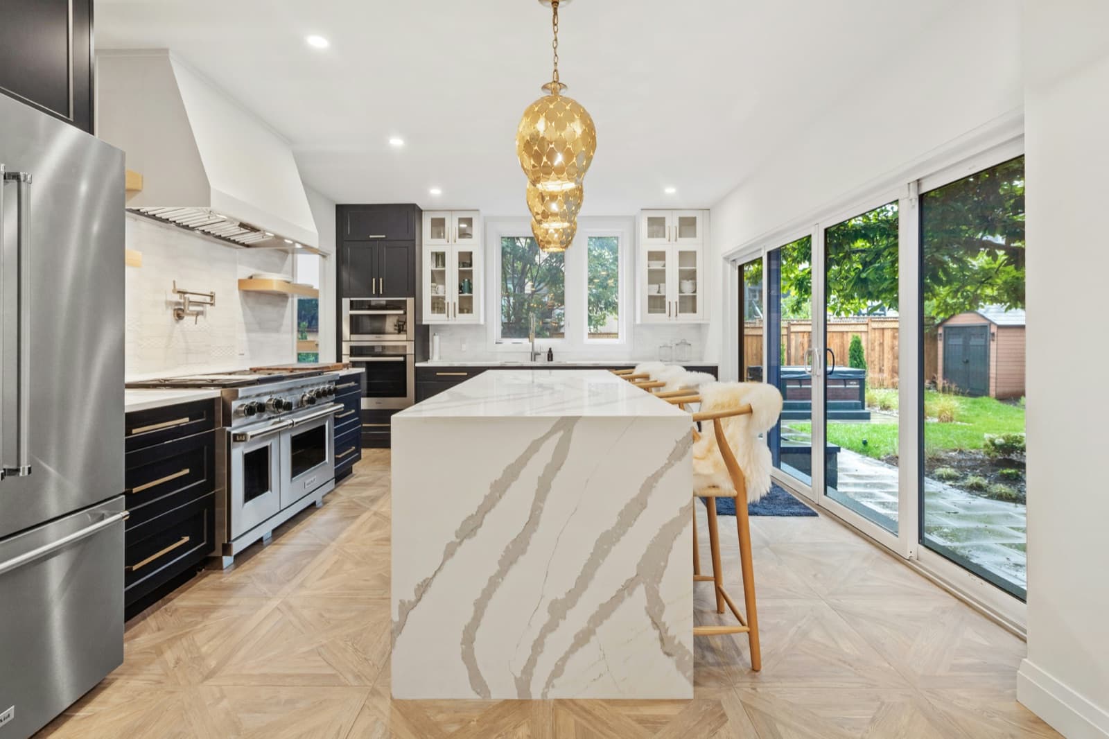 Prepared kitchen with waterfall marble island, styled for listing photography